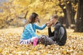 Beautiful young couple resting and kissing after successful training in the park Royalty Free Stock Photo