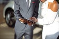 African couple getting car key from dealer in showroom and signing contract Royalty Free Stock Photo