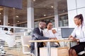 African couple getting car key from dealer in showroom and signing contract Royalty Free Stock Photo