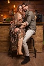 Beautiful young couple sitting at the counter and smiling to the camera Royalty Free Stock Photo