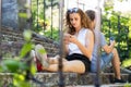 Young couple with smartphones sitting on stairs in town. Royalty Free Stock Photo