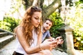 Young couple with smartphones sitting on stairs in town. Royalty Free Stock Photo