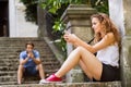 Young couple with smartphones sitting on stairs in town. Royalty Free Stock Photo