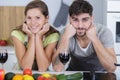 beautiful young couple smiling while cooking