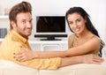 Beautiful young couple smiling on sofa Royalty Free Stock Photo