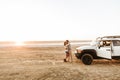 Beautiful young couple standing at the sunny beach Royalty Free Stock Photo