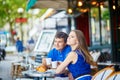 Beautiful young couple of tourists in Parisian street cafe Royalty Free Stock Photo