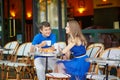 Beautiful young couple of tourists in Parisian street cafe Royalty Free Stock Photo