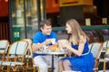 Beautiful young couple of tourists in Parisian street cafe Royalty Free Stock Photo