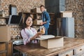 beautiful young couple unpacking boxes on kitchen while moving into Royalty Free Stock Photo