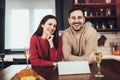 Young couple is using a digital tablet and smiling while cooking in kitchen at home Royalty Free Stock Photo