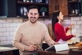 Young couple is using a digital tablet and smiling while cooking in kitchen at home Royalty Free Stock Photo