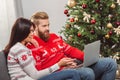 Couple using laptop at christmastime Royalty Free Stock Photo
