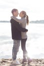 Beautiful young couple walking along the beach on a sunny spring day autumn Royalty Free Stock Photo