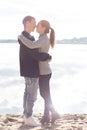 Beautiful young couple walking along the beach on a sunny spring day autumn Royalty Free Stock Photo