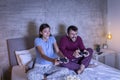 Couple playing video games in bed Royalty Free Stock Photo