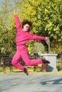 Beautiful young curly hair woman in pink sportswear and middle age 50s woman doing sports outdoors. Royalty Free Stock Photo