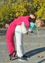 Beautiful young curly hair woman in pink sportswear and middle age 50s woman doing sports outdoors. Royalty Free Stock Photo