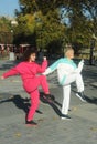 Beautiful young curly hair woman in pink sportswear and middle age 50s woman doing sports outdoors. Royalty Free Stock Photo