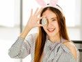 A beautiful young cute black long hair Asian woman covered her eyes with painted easter eggs Royalty Free Stock Photo
