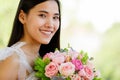A beautiful young cute black long hair Asian woman holding a sweet color roses bouquet  with happy and deep love emotion Royalty Free Stock Photo