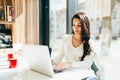 Brunette using laptop in cafe Royalty Free Stock Photo