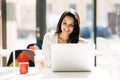 Brunette using laptop in cafe Royalty Free Stock Photo