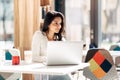 Brunette using laptop in cafe Royalty Free Stock Photo