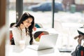 Brunette using laptop in cafe Royalty Free Stock Photo