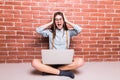 Beautiful young dark-haired girl in casual clothes with laptop Royalty Free Stock Photo