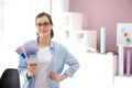 Beautiful young designer with color palette in office Royalty Free Stock Photo