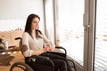 Beautiful young disabled woman in wheelchair at home. Royalty Free Stock Photo