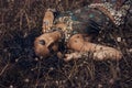 beautiful young eastern girl in ethnical jewelry lying on a grass on a field