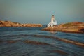 Beautiful young elegant pregnant blond woman in a blue hat walks on the beach, seashore at sunset. sea. Motherhood. Royalty Free Stock Photo