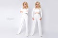 Beautiful Young elegant tall woman businesswoman standing on a white background of white pants and blouse Royalty Free Stock Photo