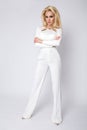 Beautiful Young elegant tall woman businesswoman standing on a white background of white pants and blouse Royalty Free Stock Photo