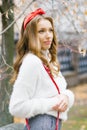 Beautiful young European woman with a red band in her hair walking outdoors in autumn Royalty Free Stock Photo