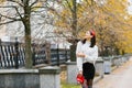 Beautiful young European woman with a red band in her hair walking outdoors in autumn Royalty Free Stock Photo