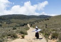 Beautiful young european woman running on road at the Horton`s plains national park