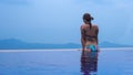 Beautiful young european woman in the swimming pool near the ocean, spa, relaxing, tropical, vacation Royalty Free Stock Photo