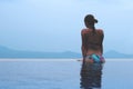 Beautiful young european woman in the swimming pool near the ocean, spa, relaxing, tropical, vacation Royalty Free Stock Photo