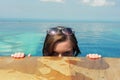 Beautiful young european woman in the swimming pool near the ocean, spa, relaxing, tropical, vacation Royalty Free Stock Photo