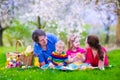 Beautiful young family with kids having picnic outdoors Royalty Free Stock Photo