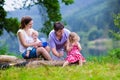 Beautiful young family with kids hiking at a lake Royalty Free Stock Photo