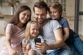 Family with kids using smartphone having fun at home Royalty Free Stock Photo