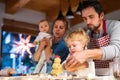 Young family making cookies at home. Royalty Free Stock Photo