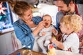 Young family making cookies at home. Royalty Free Stock Photo