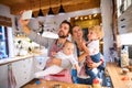Young family making cookies at home. Royalty Free Stock Photo