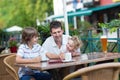 Beautiful young family in an outside cafe Royalty Free Stock Photo