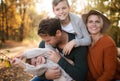 Beautiful young family with small children on a walk in autumn forest. Royalty Free Stock Photo